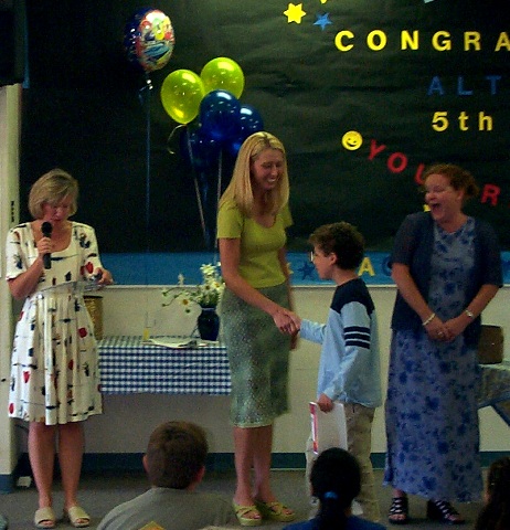 992 graduating: Here's Jeffrey with his graduation certificate being congratulated by his teachers.  His homeroom teacher is reading a paragraph talking about his favorite subject (reading) and best memory of Alta Vista (leaving Science Camp).