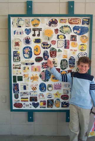 Jeffrey and his class plaque: Every year, all of the students in the 5th grade make tiles which are assembled into a plaque and hung on a wall on campus.